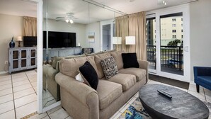 A modern living room with a sofa, a coffee table, and a TV. - Nautilus 2311  Gulf View 2BD/2BA 3rd Floor.  Free Beach Service 3/1-10/31 (Fort Walton Beach)