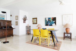 A dining area with a table, chairs, and lamps.