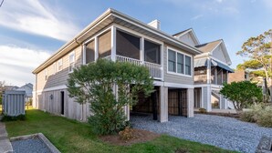 A two-story house with a covered porch and a screened balcony. - IDEAL LOCATION - ONLY A BLOCK AND A HALF TO BEACH- 208 Fourth Street, Bethany (Bethany Beach)