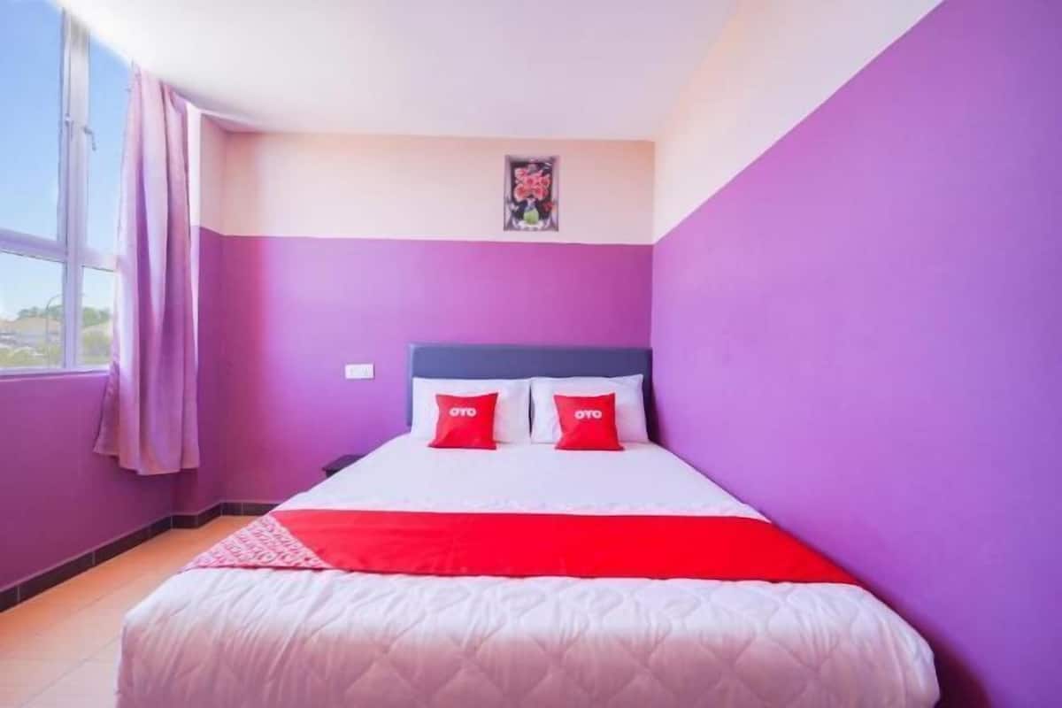 Una habitación con cama, ventana con cortinas e imagen en la pared.