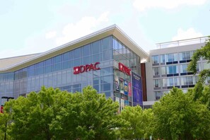 A modern building with the DPAC logo, featuring large glass windows and a prominent entrance.