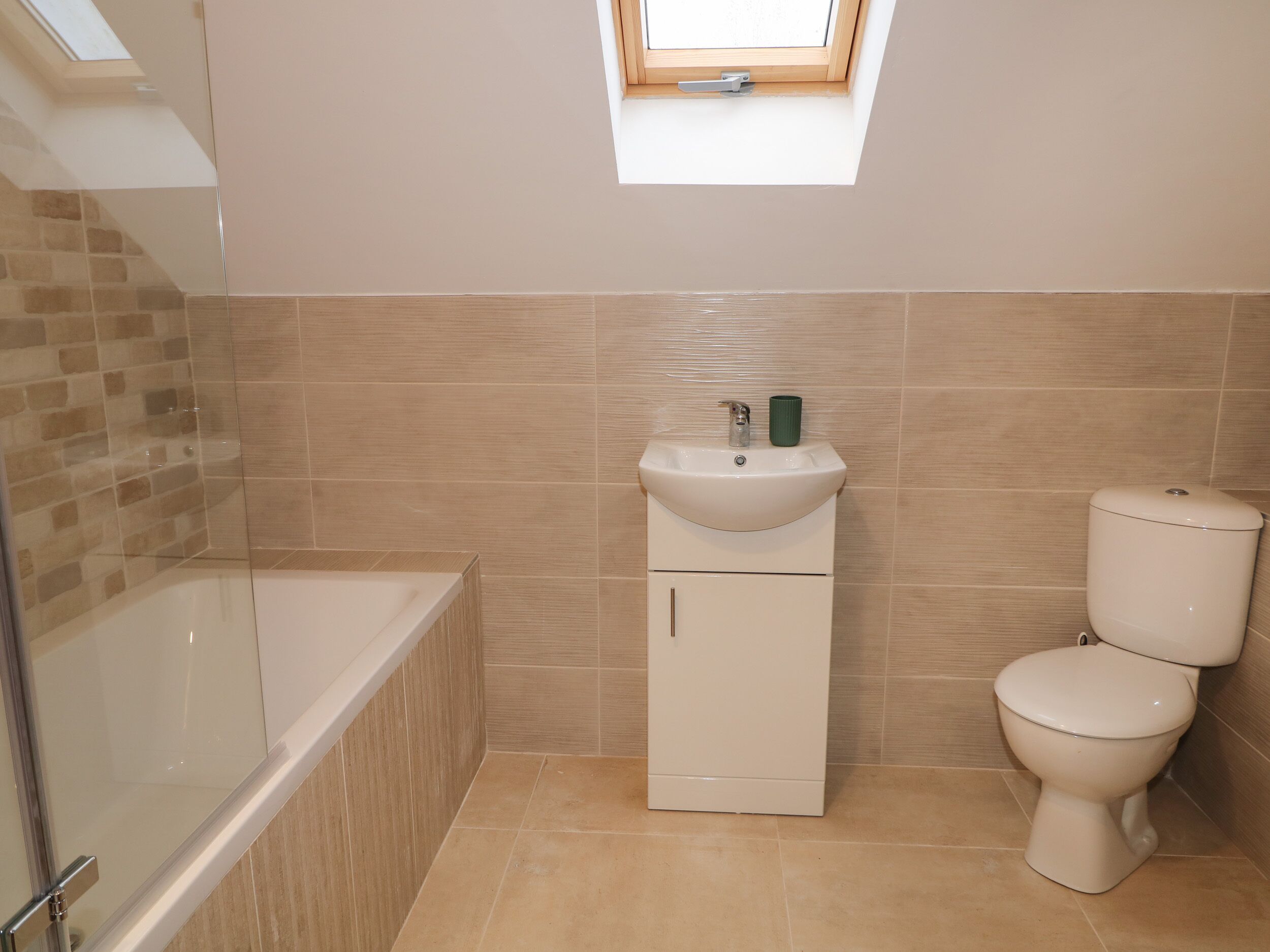 A bathroom with a bathtub, a sink, and a toilet.