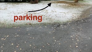 A building with a sign indicating parking.