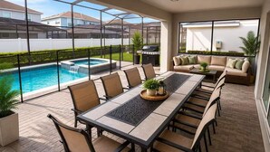 A patio with a pool, outdoor furniture, and a barbecue grill.