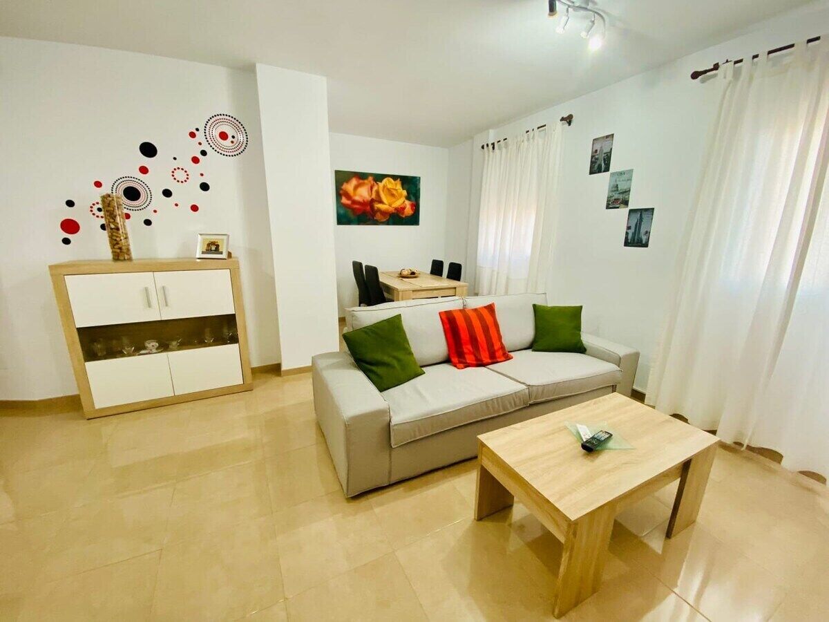 A modern living room with a sofa, a coffee table, and a cabinet.