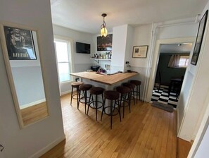 Enjoy casual dining and entertainment in this cozy kitchen with a central island and mounted TV.