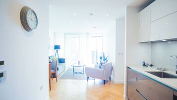 Apartment, 1 Queen Bed | Living room | 30-inch TV with cable channels