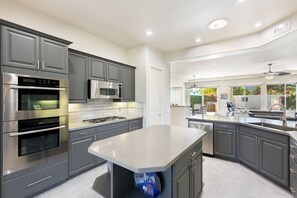 Fridge, microwave, oven, stovetop - This 3 bedroom 3.5 bathroom pool home in Lake La Quinta (La Quinta)