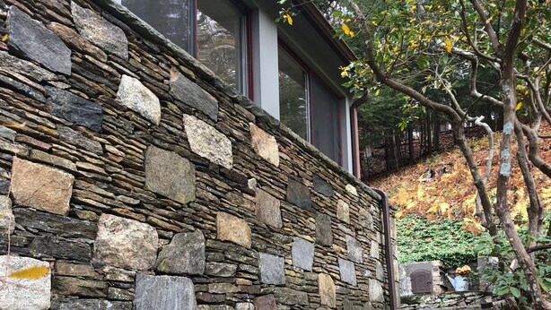 A stone staircase leading up to a building with large windows. - Historic Pound Ridge Cottage, 2 Beds, Fully Furnished (Pound Ridge)
