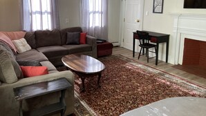 A living room with a sofa, coffee table, and a fireplace. - 🔥Warm, Spacious, Free Wine🍷Entire Apt, Self CheckIn! (Dover)