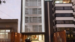 A modern hotel building with a prominent sign for the Equo Hotel. - Equo Hotel Boutique (Lima)