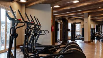 A gym with treadmills, elliptical machines, and a stationary bike.