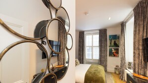 A bedroom with a bed, a dresser, a mirror, and a window with curtains. - Edinburgh Luxury Apartment- The Matisse Suite (Edinburgh)