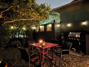 An outdoor dining area with a table and chairs, a grill, and a tree providing shade. - Stunning Ocean & Coastal Views ~Close to all (La Jolla)