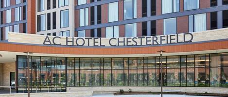 The exterior of the AC Hotel Chesterfield with a modern architectural design, large glass windows, and a prominent signage.