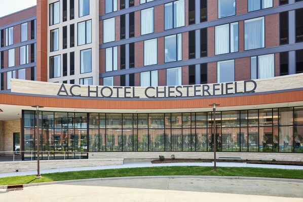 The exterior of the AC Hotel Chesterfield with a modern architectural design, large glass windows, and a prominent signage.