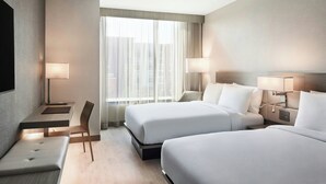 A hotel room with two beds, a desk, a chair, and a TV. - AC Hotel by Marriott St. Louis Chesterfield (Chesterfield)