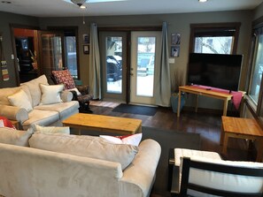 A living room with a sofa, coffee table, and TV.