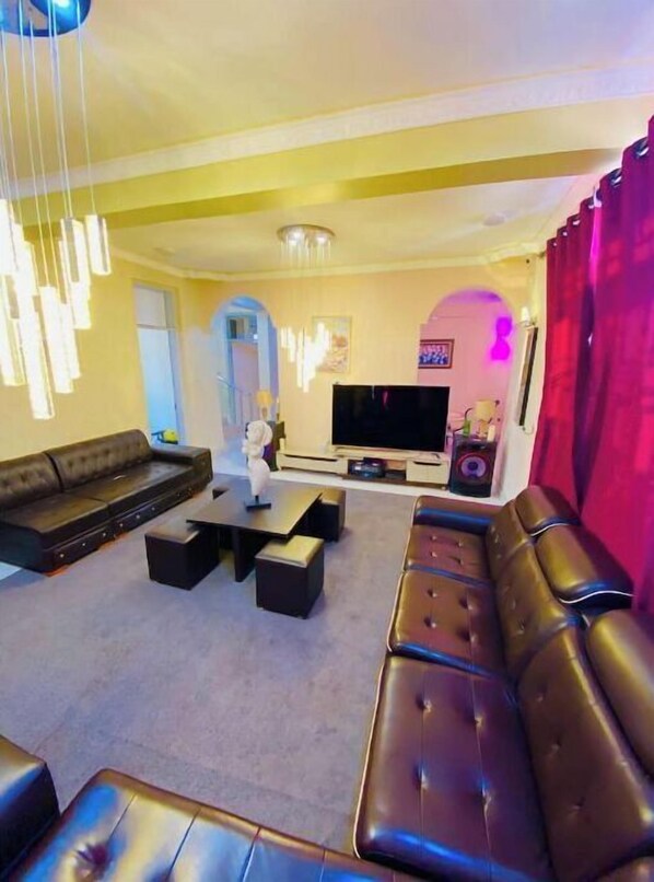 A modern living room with a sofa, coffee table, and TV.