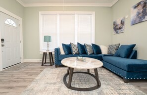 Relax in a comfortable seating area with a large sofa and coffee table.