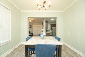 Enjoy meals in this dining area with a marble table and six comfortable chairs.