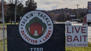 A sign for 'Talkin' Tackle Outfitters + Lodge' with a 'Live Bait Sold Here' sign beside it. - Talkin Tackle Outfitter and Lodge (Hixson)