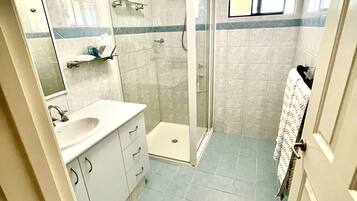 Shower, hair dryer, towels, soap