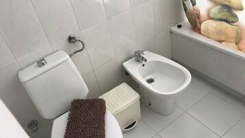 Bañera con ducha, secador de pelo, bidet, toallas