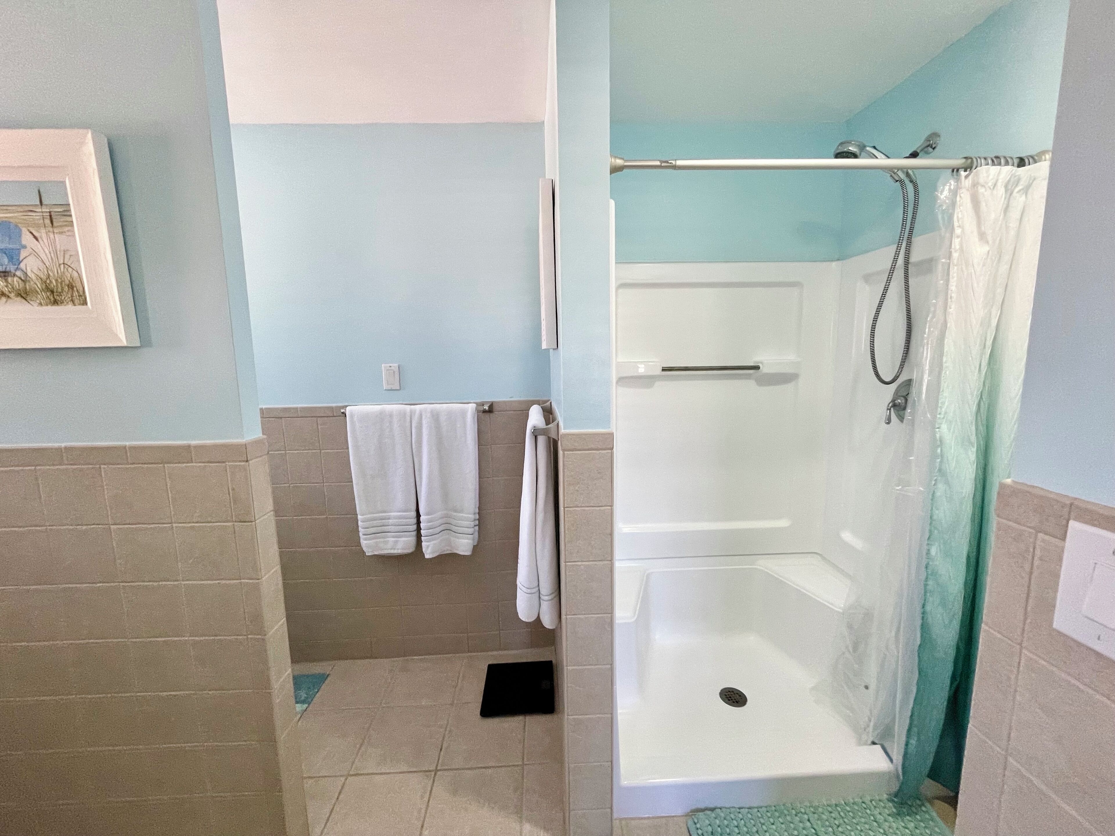 A bathroom with a shower, a bathtub, and a toilet.