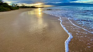 A beach with a clear sky and sunlight reflecting on the sand. - LUANA MOANA SIGNATURE OCEANFRONT MAUI-Ocean&Haleakala Views-FreeWiFi-A/C-Romance (Wailuku)