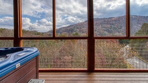 A room with a large window offering a view of a mountainous landscape. - ERN805- BEARLY BELIEVE IT! - GREAT LOCATION! CLOSE TO TOWN AND ALL THE ACTION! (Pigeon Forge)