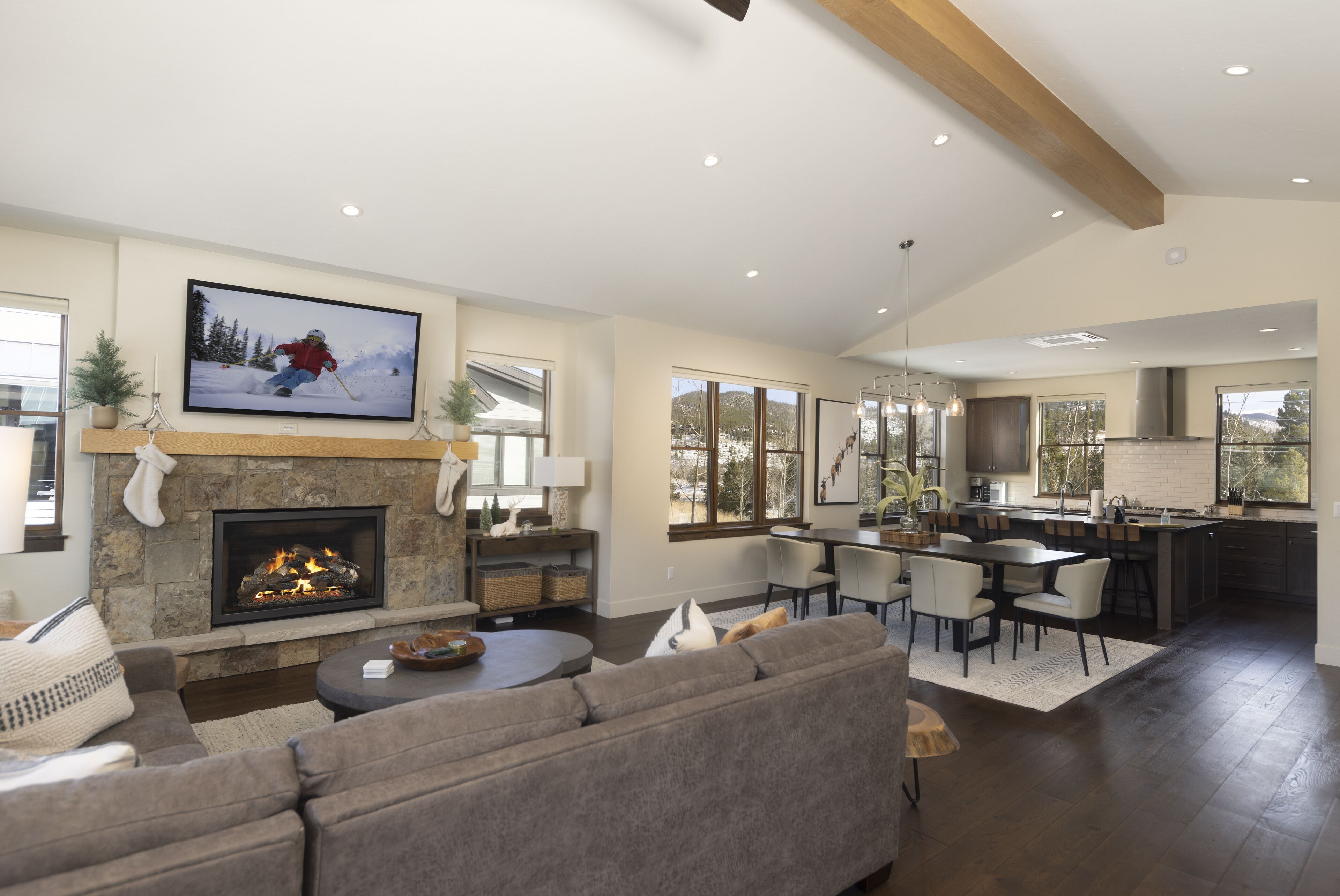 A spacious living room with a fireplace, a large TV, and a cozy seating area.