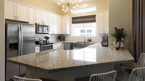 A modern kitchen with granite countertops, stainless steel appliances, and a central island. - Eucalyptus by AvantStay | Stunning Scottsdale Home w/ Communal Pool & Hot Tub (Scottsdale)
