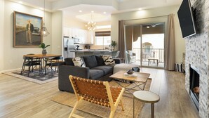 A spacious living area with a sofa, a dining table, and a coffee table. There is a fireplace and a ceiling fan. - Eucalyptus by AvantStay | Stunning Scottsdale Home w/ Communal Pool & Hot Tub (Scottsdale)