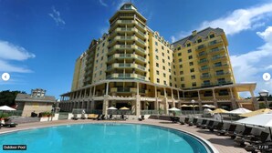 A hotel with a large outdoor pool, multiple balconies, and a clear blue sky. - St. Augustine Villa for 6 Golf courses, tons of amenities & close to attractions (St. Augustine)