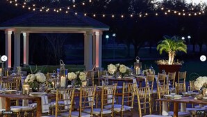 An outdoor dining area with tables set for a formal event, featuring gold chairs, white tablecloths, and floral centerpieces. - St. Augustine Villa for 6 Golf courses, tons of amenities & close to attractions (St. Augustine)
