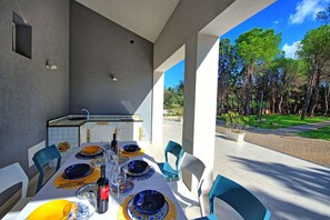 Enjoy a meal amidst the serene forest surroundings from this outdoor dining area.
