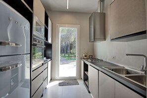 Enjoy cooking in this well-equipped kitchen with a gas stove, sink, and stainless steel appliances.