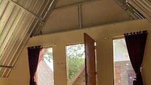 A tented room with mats, a bed, and a window with curtains. - Supercamp Sakura Hills (Tawangmangu)