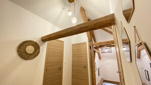 A wooden staircase with a rustic design, a round mirror, and a ceiling light fixture. - Superb Duplex 8/10 pers 5ch 3sdb 1 balcony 150M2 cocooning in the heart of Queyras (Aiguilles)