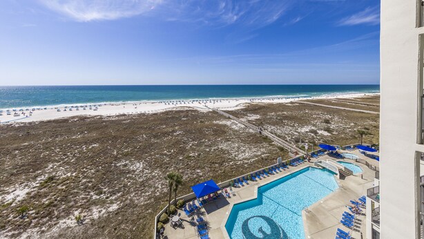 A resort with a large pool, beach access, and a view of the ocean. - Phoenix VI 813 | Pools | Beachfront | Racquetball | My Beach Getaways (Orange Beach)