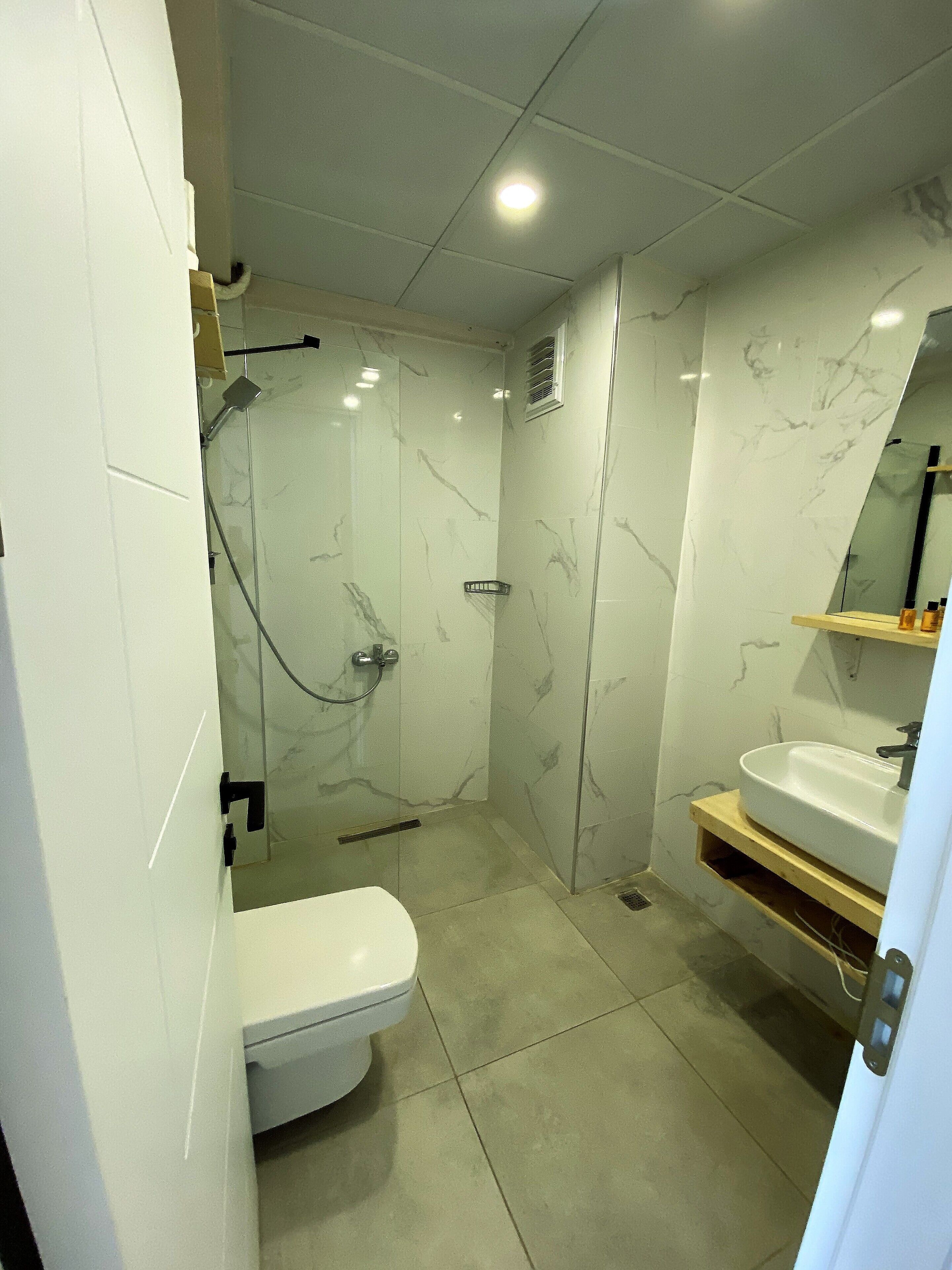 studio suite | bathroom | shower, free toiletries, hair dryer, towels