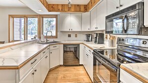 A modern kitchen with white cabinetry, a stainless steel range, and a dishwasher. - Sunny Alpine Escape w/ Hot Tub + Mountain Vistas! (Fraser)