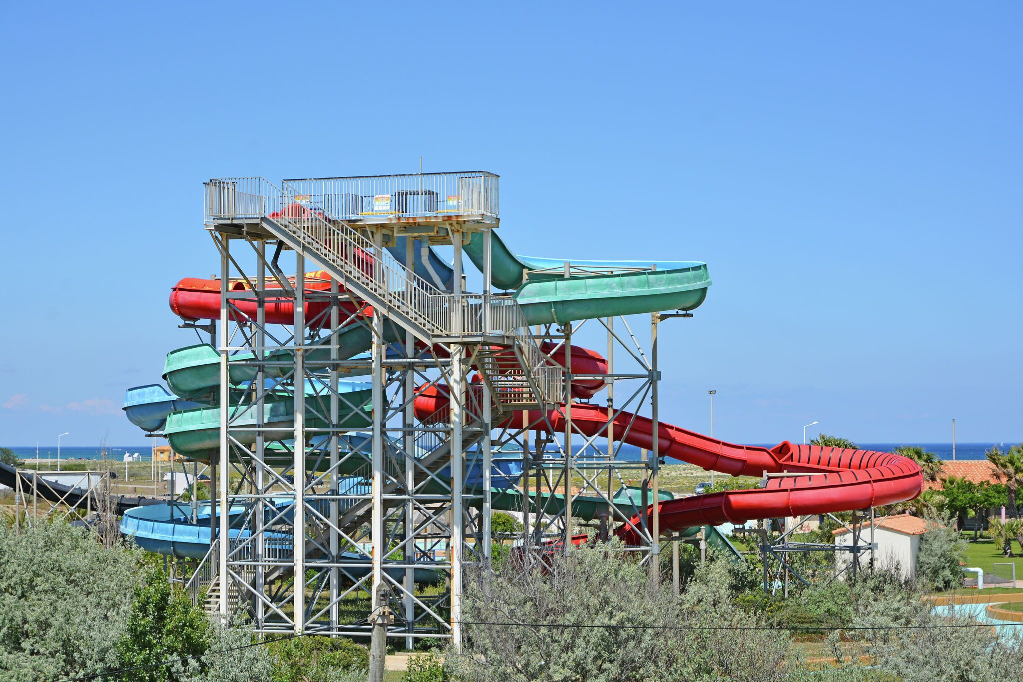A water park with multiple slides and a viewing platform.