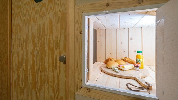 A wooden door with a number '2' sign, a window with a wooden interior, and a breakfast setup including croissants, cheese, and juice. - Appart Hotel En Ville - Studio 2 persons in the center of Bastogne (Bastogne)