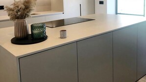 A modern kitchen with a large island, recessed ceiling lights, and a window providing natural light. - Stunning 'Finca Clos' with Mountain View, Private Pool, Garden, A/C & Wi-Fi (BORRASSA)