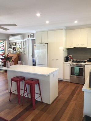 Enjoy cooking in this well-equipped kitchen with a central island and stainless steel appliances.
