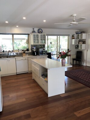 Enjoy cooking in this well-equipped kitchen with a large island, microwave, and dishwasher.