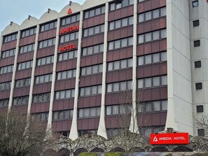 A multi-story hotel with a prominent red sign reading "AMEDIA HOTEL." - City Hotel Siegen (Siegen)