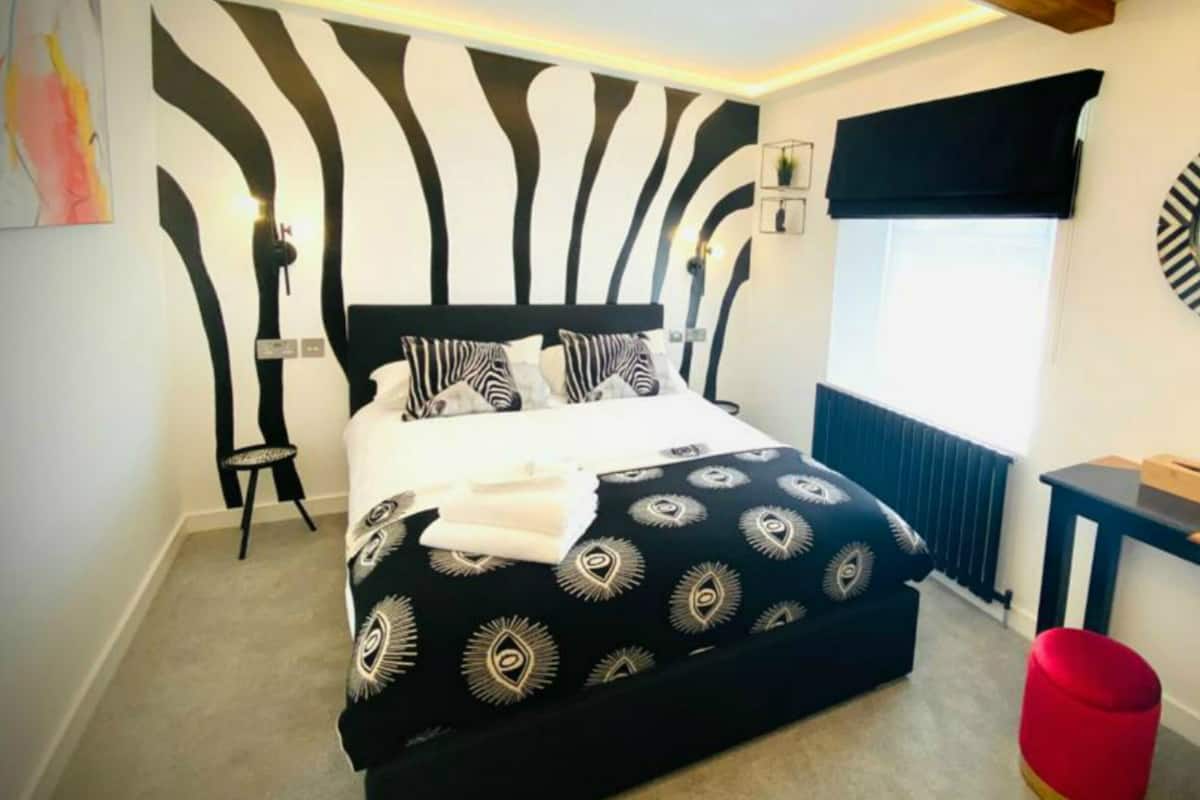 Zebra Room | Desk, laptop workspace, blackout drapes, iron/ironing board